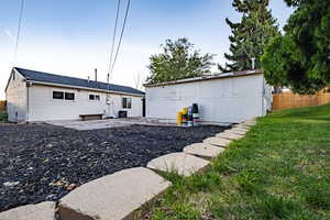 Back of property featuring a yard and a patio area