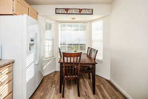 Dining area featuring dark wood-type flooring