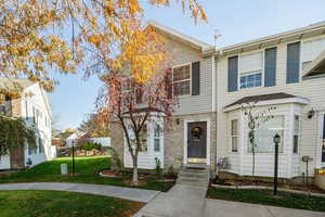 Townhome / multi-family property featuring a front yard