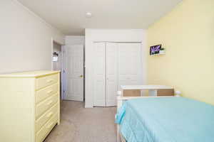 Bedroom with a closet and crown molding