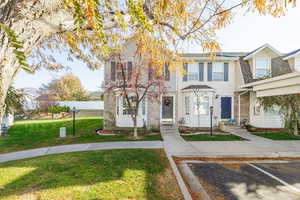 Townhome / multi-family property featuring a front yard