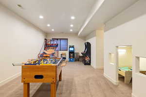 Playroom featuring part of family room with play house.