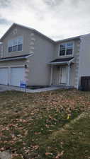 View of front property featuring a garage and a front yard