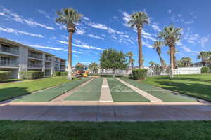 View of home's community featuring a playground and a lawn