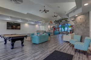 Game room with pool table, wood-type flooring, and ceiling fan