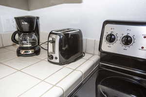 Room details with tile counters, tile patterned flooring, and washer / clothes dryer