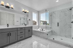 Bathroom featuring vanity, a textured ceiling, and independent shower and bath