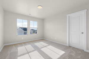 Unfurnished room with light carpet