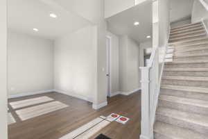 Stairs with hardwood / wood-style floors