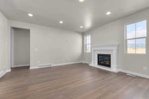 Unfurnished living room featuring hardwood / wood-style flooring