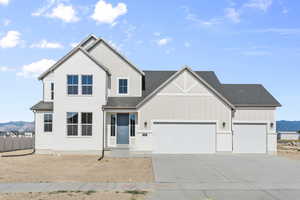 View of front facade with a mountain view and a garage