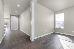 Corridor with plenty of natural light and dark hardwood / wood-style floors