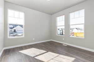 Unfurnished room featuring dark hardwood / wood-style flooring