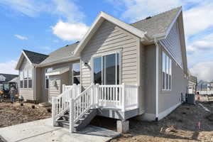 View of front of property featuring a patio area and central AC