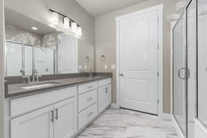 Bathroom with vanity and an enclosed shower