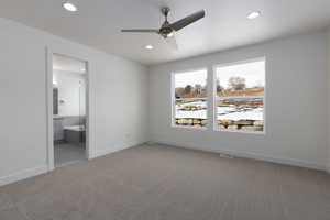 Unfurnished bedroom featuring carpet, ensuite bath, and ceiling fan