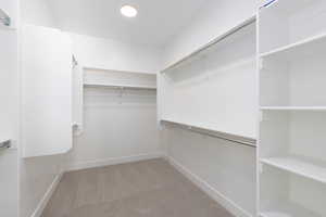 Spacious closet with light carpet