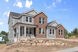 View of front of house with central AC unit and a porch