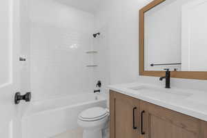 Full bathroom with tile patterned floors, vanity, toilet, and tiled shower / bath combo