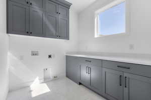 Washroom featuring cabinets, washer hookup, gas dryer hookup, and hookup for an electric dryer