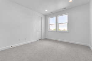 Carpeted empty room featuring a textured ceiling