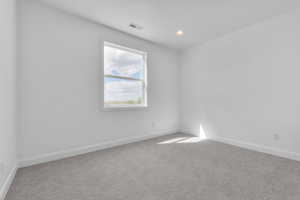 Empty room with light colored carpet