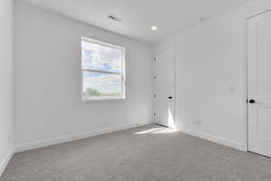 Unfurnished room with light carpet