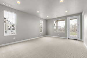 Unfurnished room with light carpet