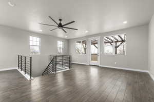 Unfurnished room with dark hardwood / wood-style flooring and ceiling fan