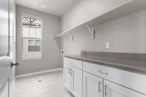 Washroom with cabinets and hookup for a washing machine