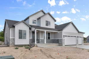 View of front facade featuring a garage and covered porch