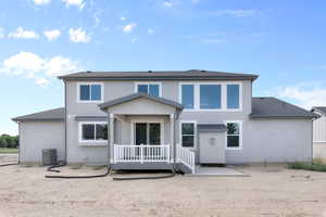 Rear view of house with central AC unit and a patio