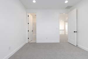 Empty room with light colored carpet