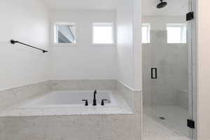 Bathroom featuring shower with separate bathtub