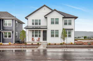 Modern farmhouse style home featuring central air condition unit, a mountain view, and covered porch