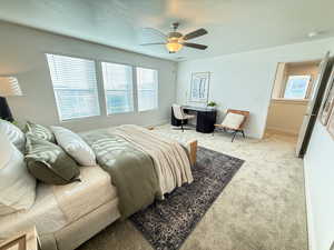 Bedroom with ceiling fan and light colored carpet