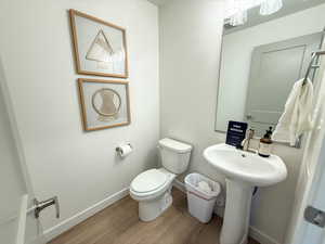 Bathroom featuring sink, hardwood / wood-style floors, and toilet