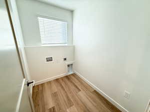 Washroom featuring hookup for an electric dryer, washer hookup, and light hardwood / wood-style flooring