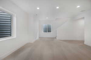 Bonus room with light colored carpet