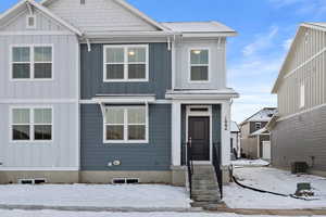 View of front of property with central AC unit