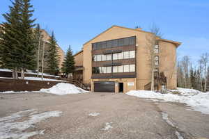 Snow covered building featuring a garage