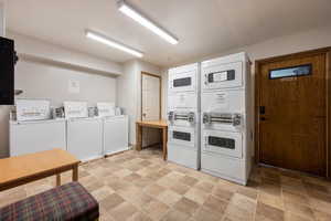 Washroom with stacked washer and clothes dryer and independent washer and dryer