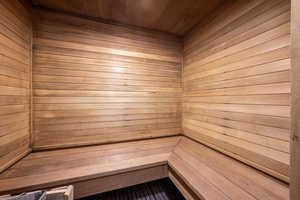 View of sauna featuring wooden walls and wooden ceiling