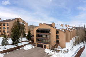 Snow covered building featuring a garage