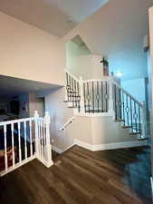 Stairs featuring hardwood / wood-style flooring