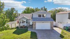 View of front of house with a garage and a front yard