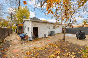 Rear view of house featuring central AC