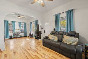 Living room with hardwood / wood-style flooring and ceiling fan