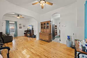 Living room featuring light wood-type flooring and ceiling fan