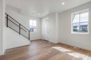 Foyer entrance featuring a wealth of natural light and light hardwood / wood-style floors